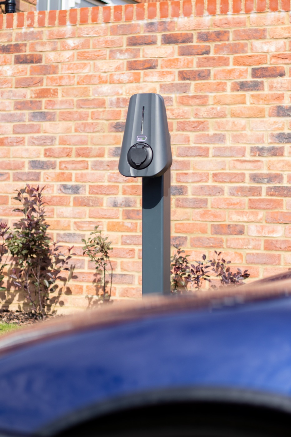 Brim charger installed on the brick wall of a new-build home