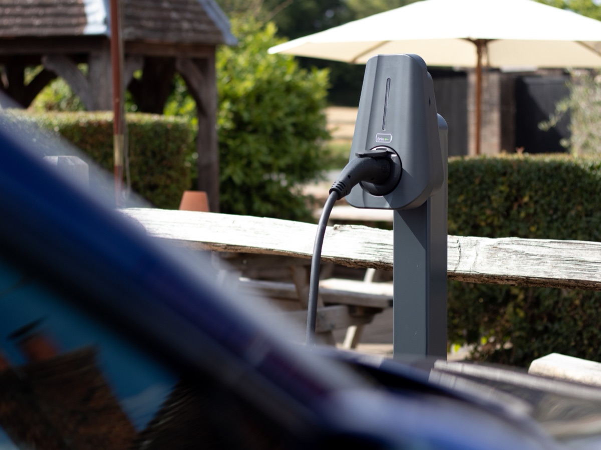 A Brim charger mid-session with a cable running to a car